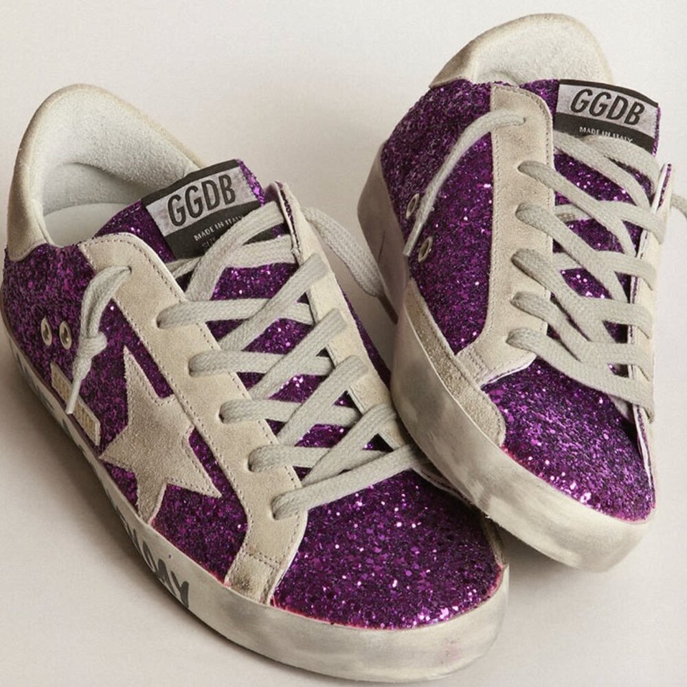 Golden Goose Super-Star sneakers with purple glitter and lettering on the foxing